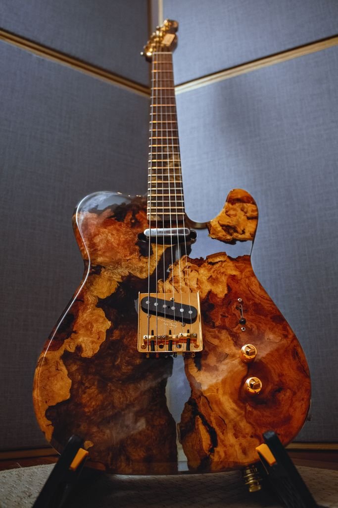 Artistic electric guitar with a stunning epoxy wood finish, handcrafted and unique.